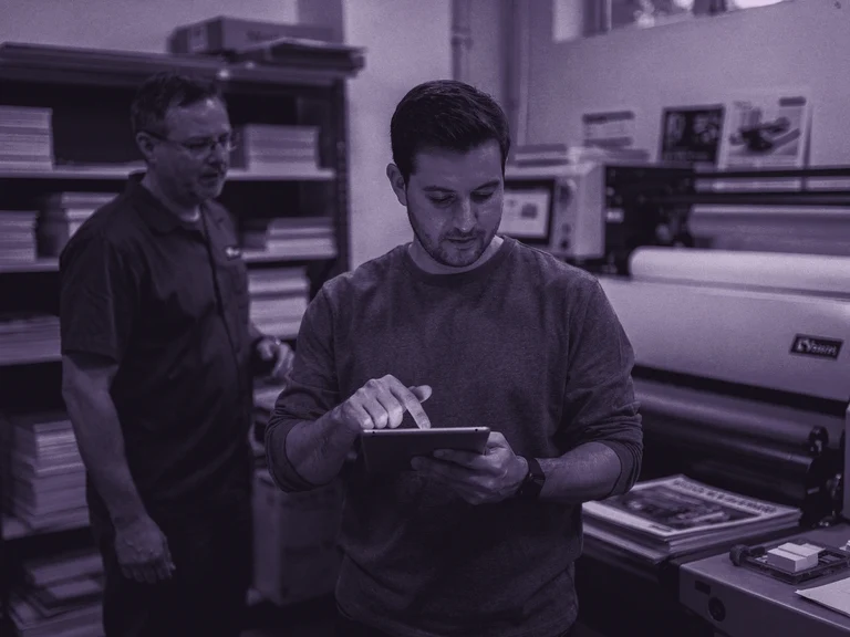 A project lead reviews a digital proof before production proceeds