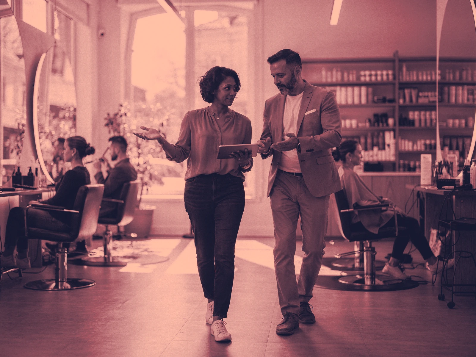 A digital consultant and salon owner review a customer booking and CRM workflow while walking through the active business