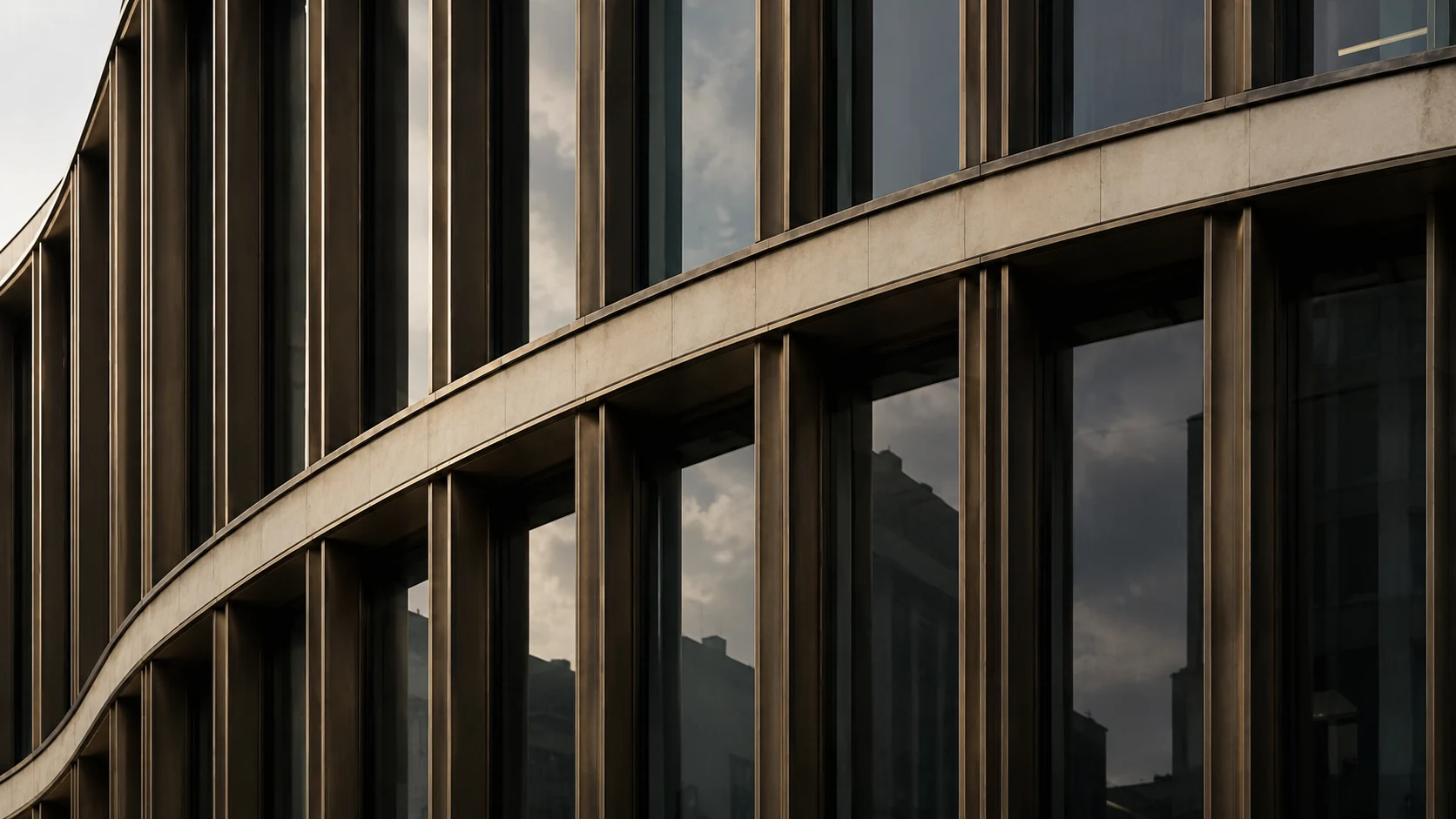 Curved office facade with bronze fins and dark reflective windows